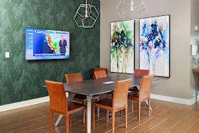 a large dining room with a table and chairs