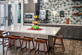 a kitchen with a large counter and some bar stools