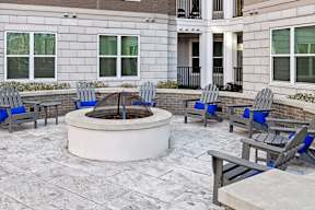 an outdoor patio with chairs and a fire pit