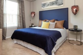 a bedroom with a large bed and a blue headboard
