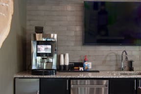 a kitchen with a coffee maker and a counter with a sink