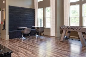 a game room with a foosball table and a table and chairs