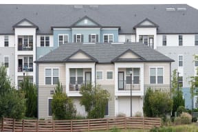 a row of town houses with a fence in front of them