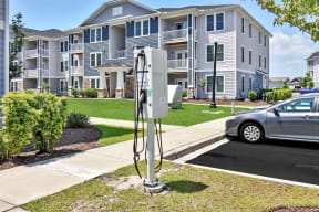 an electric car station in front of an apartment building