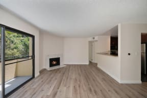 a living room with a fireplace and hardwood floors at Croft Plaza Apartments, California