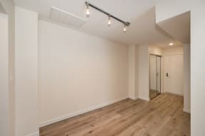 a bedroom with hardwood floors and white walls at Croft Plaza Apartments, West Hollywood