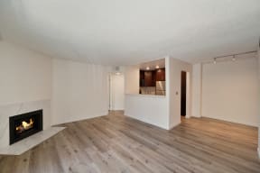 a living room with a fireplace and hardwood floors at Croft Plaza Apartments, West Hollywood, 90069