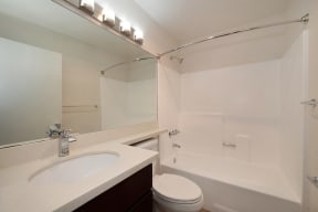 a bathroom with a sink toilet and bathtub at Croft Plaza Apartments, West Hollywood, CA 90069