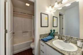 Bathroom with Granite Counters, Bathrub, Sink and Vanity at Hidden Oaks Apartments, Citrus Heights, 95621