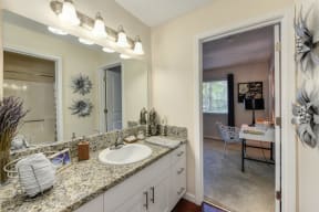 Bathroom with Vanity , Granite Counters and View of Bedroom at Hidden Oaks Apartments, California