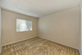 Bedroom with Window, Carpet and White Walls at Hidden Oaks Apartments, Citrus Heights, 95621