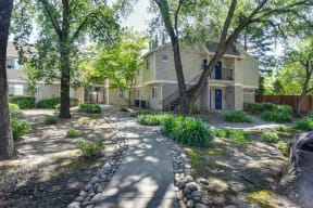 Apartment Exterior Walkways with Trees and Grass at Hidden Oaks Apartments, California