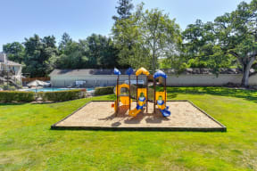 Playground with Sand, Grass and Apartment Exteriors at Hidden Oaks Apartments, California