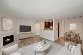 a living room with a fireplace and a dining room in the background at Croft Plaza Apartments, West Hollywood, CA 90069