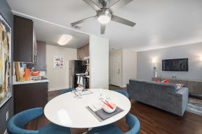 a living room and kitchen with a white table and blue chairs at Folsom Ranch, Folsom, 95630