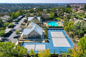 Drone View of Community showcasing the sports court areas and pool area in the distance at Folsom Ranch, California