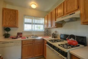 Kitchen with Dishwasher, Oven Range and Refrigerator at Olympus Park Apartments, Roseville, California