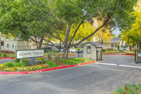 Monte Bello Community Entrance with monument sign, entry gate and small guard-like station at the entry gate. at Monte Bello Apartments, Sacramento, CA, 95826