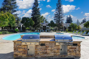Community Outdoor BBQ and Picnic Area with Grills, Pools and mature landscaping. at Monte Bello Apartments, Sacramento ,95826