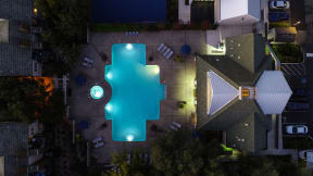 Nightime Drone of Pool Area with Lounge Chairs, Trees and Plants at Folsom Ranch, California