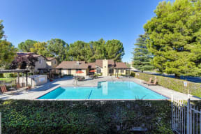 Swimming Pool, Lounge Chairs, and Gates Seperating from other Apartments