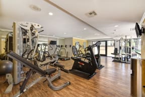 Community fitness center with numerous weight machines and cardio machines.