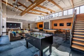 a game room with a foosball table and a ping pong table