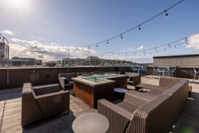 a view of the rooftop terrace with couches and tables