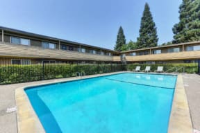 Outdoor Swimming Pool with Bushes and Apartment Exteriors  at Olympus Park Apartments, California, 95661