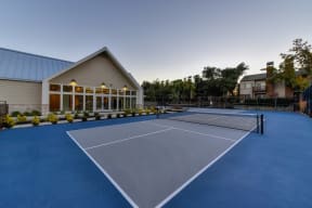 Several sport courts with Fitness Center in the surrounding building. Exterior is landscaped with mature Trees and bushes at Folsom Ranch, California, 95630