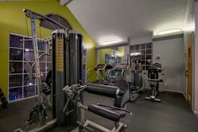 A gym with a variety of equipment including a leg press machine.