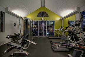 A gym with treadmills and exercise bikes.