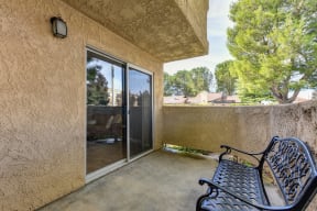 Apartment home patio on the first floor.  Patio is enclosed and there is a park bench on this patio. 