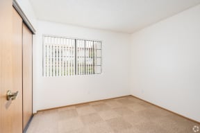 a bedroom with a door and a window