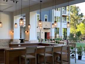 Outdoor bar seating area behind the clubhouse