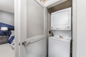 a small laundry room with a washer and dryer on the door