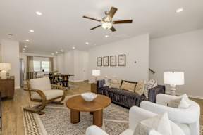 Open concept living and dining room with ceiling fan at The Courts at Maverick Yards Apartments, Mauldin, South Carolina