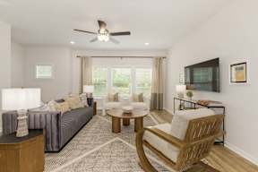 Spacious living room with modern furnishings at The Courts at Maverick Yards Apartments, Mauldin
