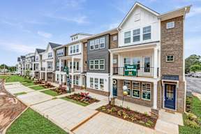 Row of modern townhomes with front patios at The Courts at Maverick Yards Apartments, Mauldin, SC