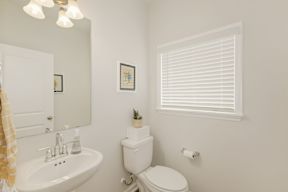 Bright bathroom with pedestal sink and white blinds at The Courts at Maverick Yards Apartments, Mauldin, 29662