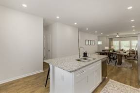 Kitchen island with granite countertop at The Courts at Maverick Yards Apartments, Mauldin, South Carolina