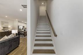 Staircase with wood treads and handrail at The Courts at Maverick Yards Apartments, South Carolina