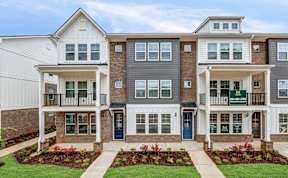 Modern townhome exteriors with balconies and landscaping at The Courts at Maverick Yards Apartments, Mauldin, SC 29662