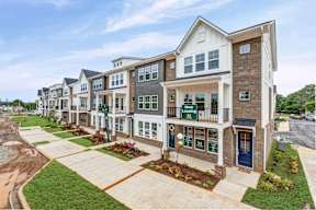 Row of three story townhomes with garage entrances at The Courts at Maverick Yards Apartments, South Carolina, 29662