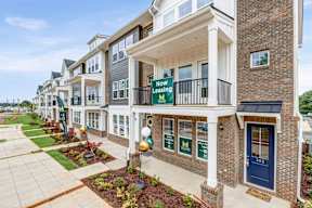 Townhome facade with now leasing signs at The Courts at Maverick Yards Apartments, Mauldin, South Carolina