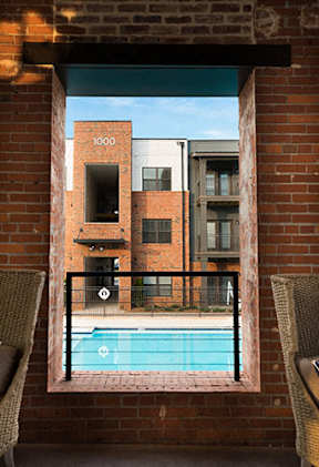 A view of Cotton Mill Apartments' pool through a door.