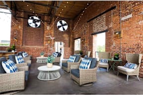 Cotton Mill Apartments open-air community patio with coffee table and chairs