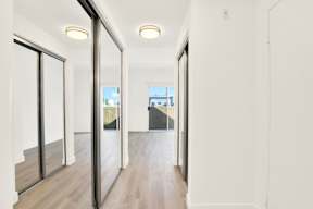 A long hallway with sliding doors on both sides.