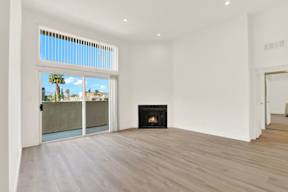 A living room with a fireplace and sliding glass doors.