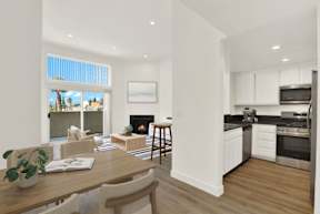A modern kitchen with a dining table and chairs.